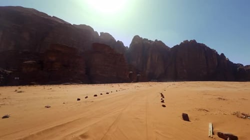 A Stunningly Beautiful Desert Landscape Featuring Radiant Sunlight and a Majestic Mountain Backdrop