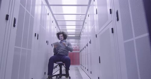 Man Working on Tablet in Server Room