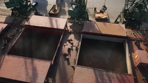 Aerial View of Big Cargo Ship Bulk Carrier is Loaded with Grain of Wheat in Port at Sunset