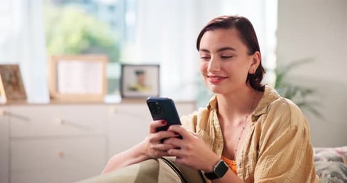 Smiling Woman Using Smartphone in Bright Home