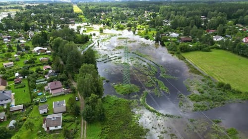Suburban neighborhood heavily flooded by storm waters, affecting homes and green areas