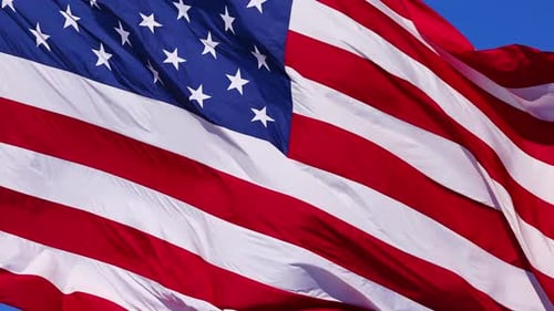 American Flag Waving Proudly Against a Blue Sky