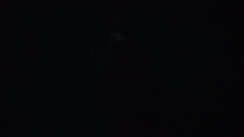 Female Model Against Bright Strobe Lightning on Black Background in Studio Woman Profile Silhouette