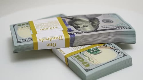 Stack of Bank Bundles with US Dollars on a White Background Closeup Shot of New Freshly Printed