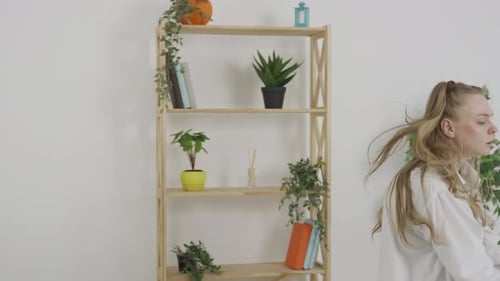 Woman Dancing Expressively in Modern Living Room