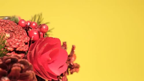 Closeup of New Year's Green Wreath on a Yellow Background