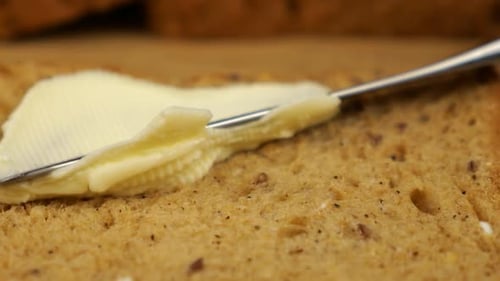 Spreading Butter on Toast Slice Macro Shot