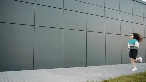 Woman Runs Along Sidewalk for Fitness