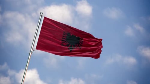 Realistic Albanian Flag Waving Against Blue Sky