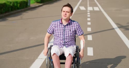 Man in Wheelchair on Path Outdoors
