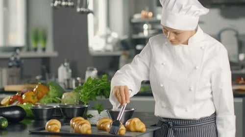 Chef Glazes Croissants in Commercial Kitchen
