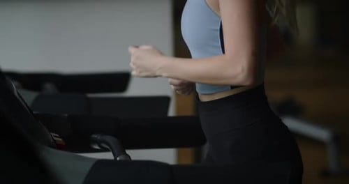 Treadmill Workout at Indoor Fitness Gym Fitness Woman Running on a Treadmill in the Gym Athlete Uses