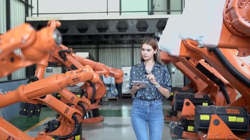 Engineer woman working inside robotic factory - Tech industry concept