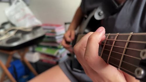 Close Up Of Guitar Strings Strumming Indoors