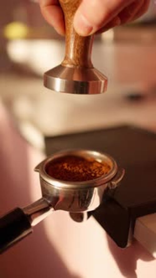 Hand Tamping Coffee Grounds in Portafilter with Tamper