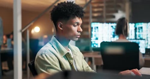 Man, developer and coding a video game in office and working on futuristic software