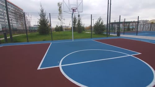 Basketball Playground with Colorful Court in Urban Park