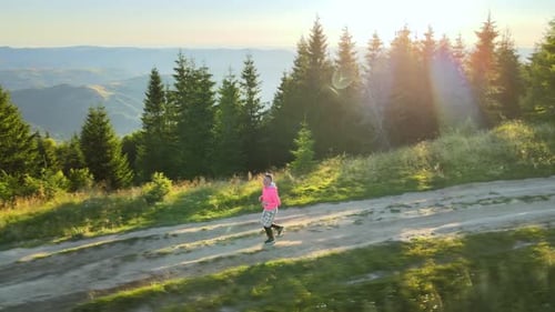 Jogger Training on Mountain Trail at Colorful Sunrise Man Running on Highland Dirt Road Alone
