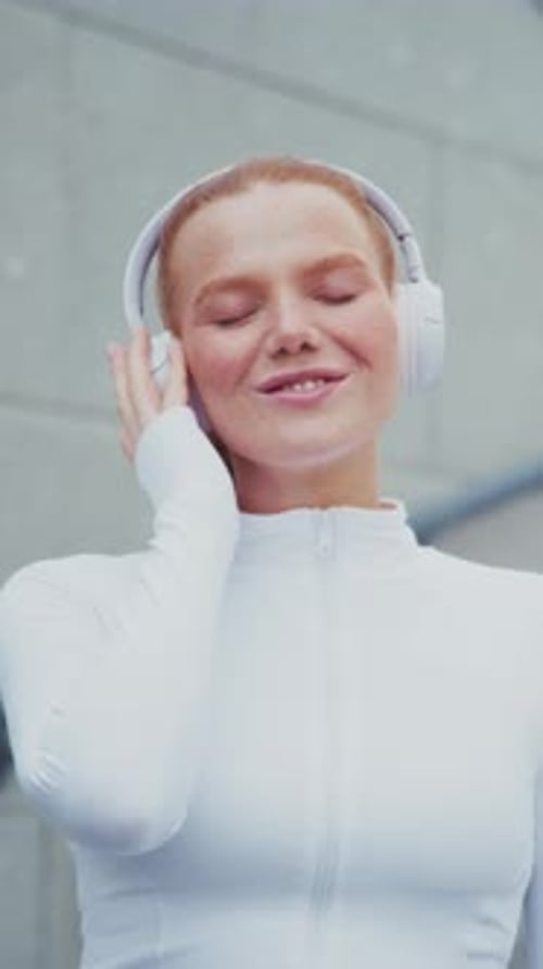 Woman Listening to Music in Urban Setting
