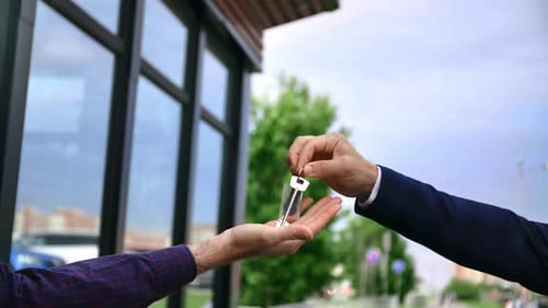 Male Real Estate Agent Giving Keys to Client Buyer of Countryside House Property Purchase Deal