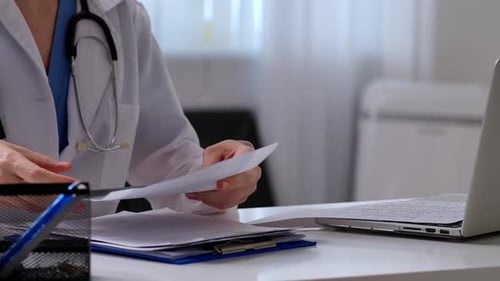 Medical Professional Writing Prescription in Office Setting