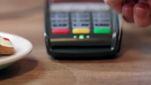 Human Hand Swipe Credit Card in Pos Terminal. Detail of Card Terminal