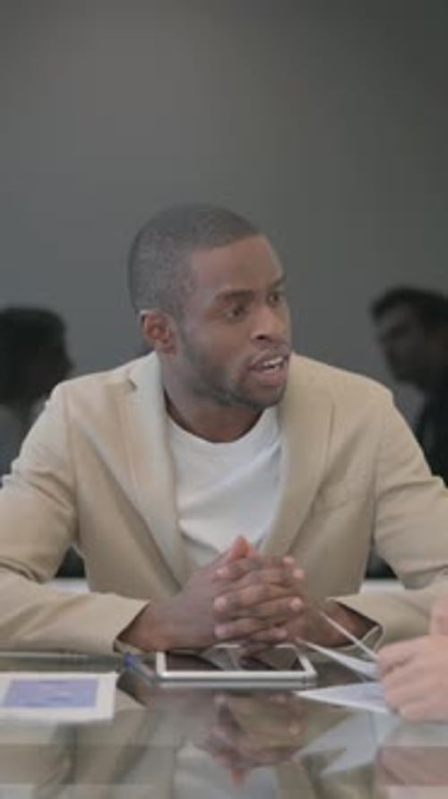 Business Man Discussing Charts in Modern Office Setting