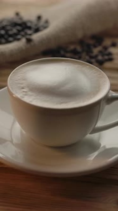 Vertical of Coffee Cup with Cappuccino Drink on Wooden Table