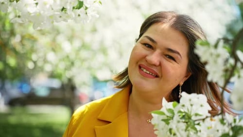 Business Woman Portrait in Blossoming Apple Trees