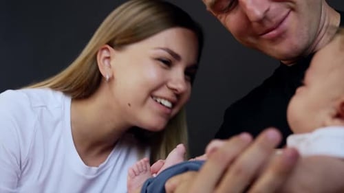 Loving Family Moment with Smiling Parents and Baby