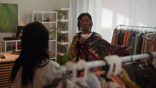 Two Diverse Friends Shopping for Clothes in Cozy Vintage Store