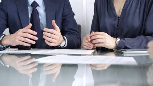 Business People Discussing Documents in a Modern Office