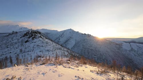 Winter Sunrise Over Snow Covered Mountains
