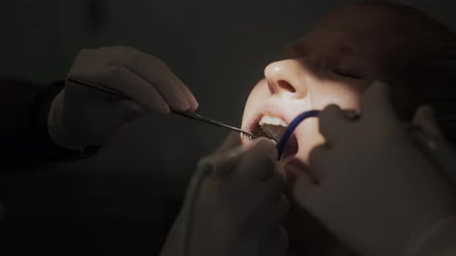 A Young Woman in the Dentist's Office in the Process of Dental Treatment