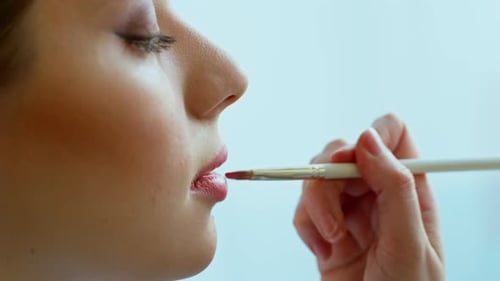 Close Up of Woman Applying Red Lipstick