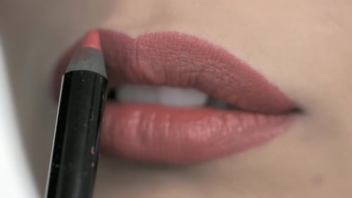 Woman Applies Lip Liner Close Up
