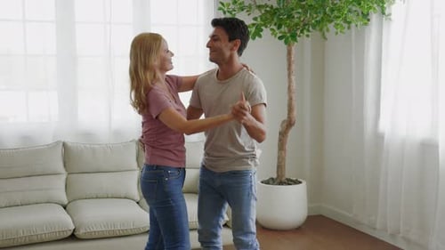 Affectionate Couple Dancing Together in Living Room