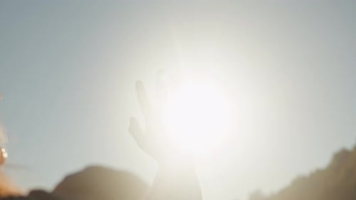 Hand of Young Woman at Sunset Closeup Sun Between the Hands of Tourist Woman Silhouette of Happy