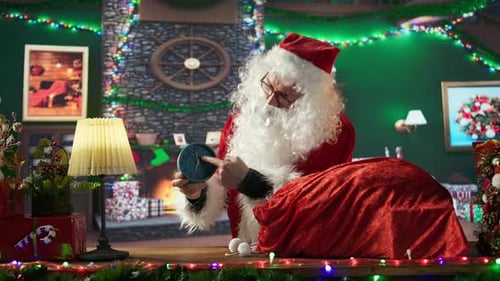 Santa Clause packing gifts in festive room