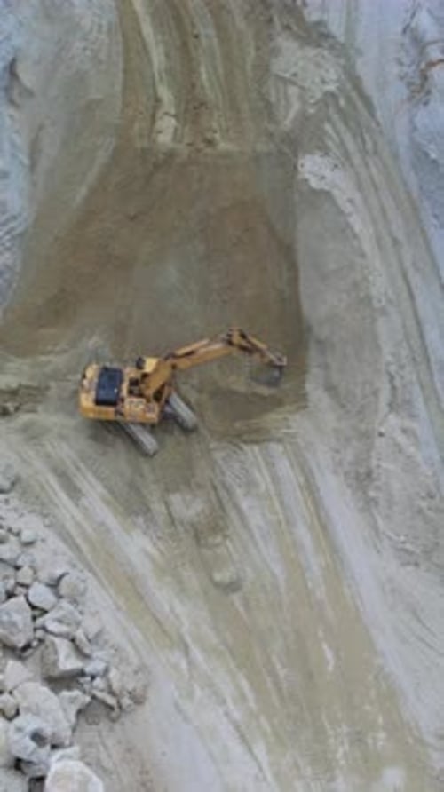Construction Machinery in Operation Mining Site Activity with Dust Clouds and Precise Machine