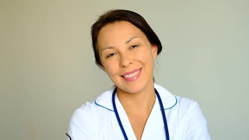 Slow Motion Close Up of a Beautiful Young Woman Lady Doctor Looking at Camera Concept of Profession