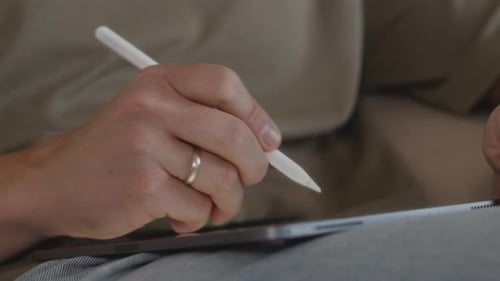 Close Up of Male Hand Drawing on Tablet From Low Angle