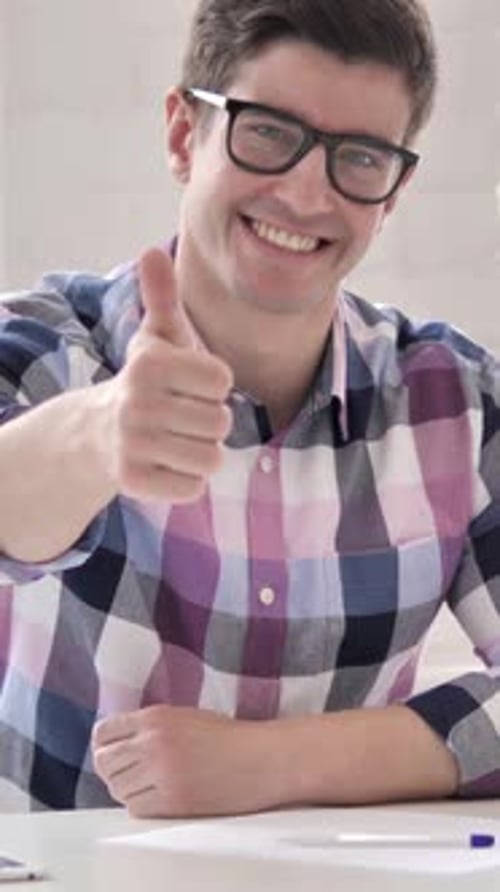 Thumbs Up by Young Man in Office Looking at Camera, Vertical Video