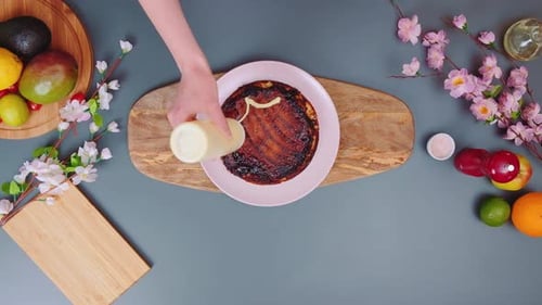 Cream Sauce Being Drizzled on Fresh Pancake