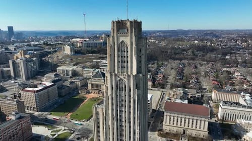Aerial orbit around Cathedral of Learning at University of Pittsburgh. Pitt establishing shot in win