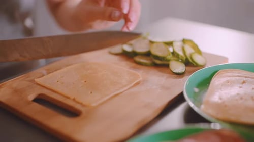 Cutting cheese on wooden board in a kitchen