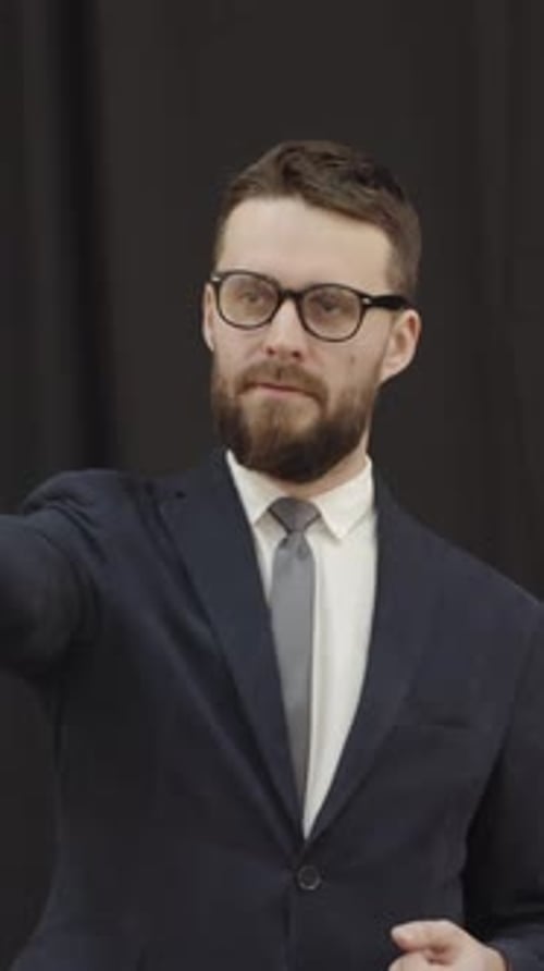 Suited Man at Live Auction