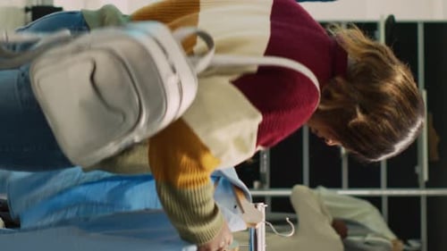 Woman Looks Through Clothing Rack At Store