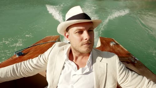 Happy Caucasian Male Person Relaxing on Boat Riding in Peaceful Lake Landscape