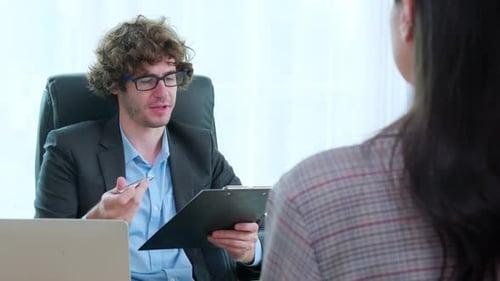 Young asian business woman sitting and job interview with caucasian manager at office.
